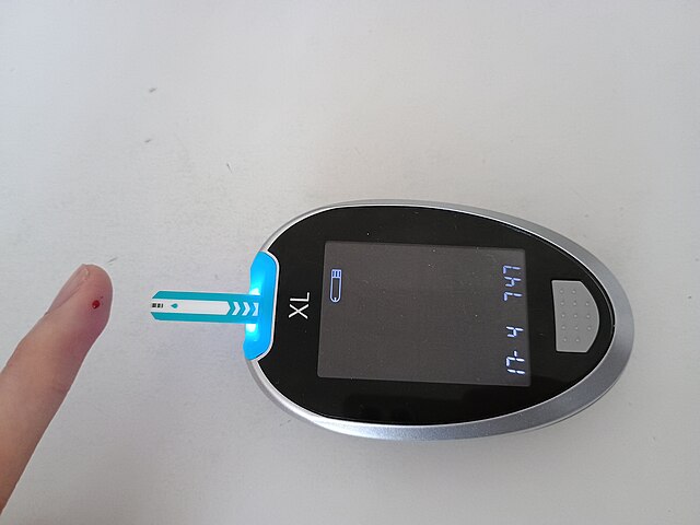 Fingerstick glucose meter on a table